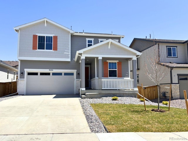 9092 Telluride Ct, Commerce City, CO 80022 - view of front of property featuring a porch, a garage, brick siding, and driveway