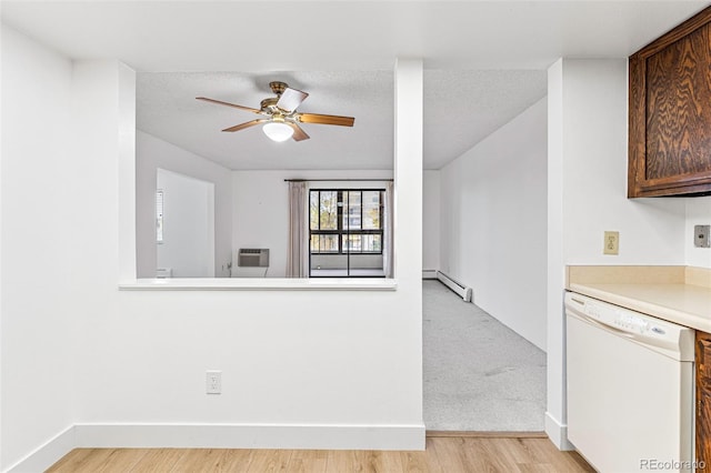 kitchen featuring a wall unit AC, a textured ceiling, light hardwood / wood-style flooring, a baseboard heating unit, and dishwasher