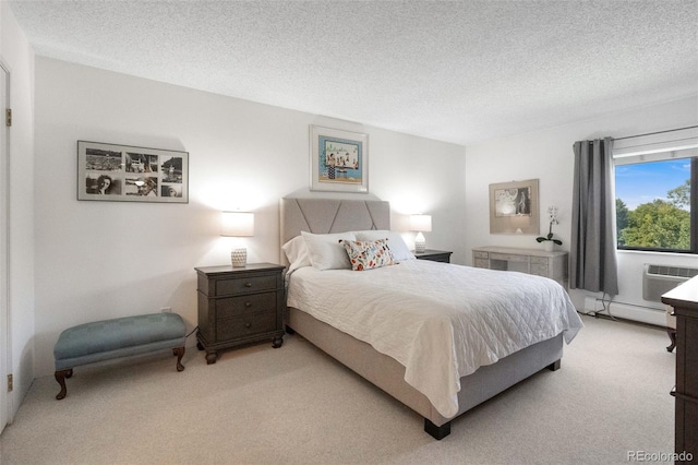 carpeted bedroom featuring a baseboard radiator and a textured ceiling