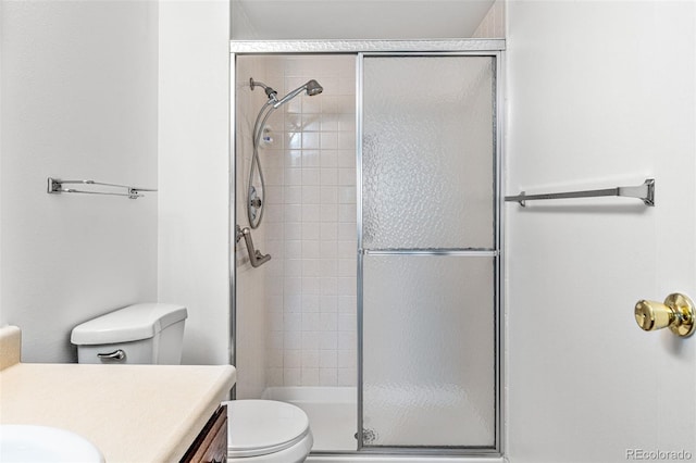 bathroom featuring walk in shower, vanity, and toilet