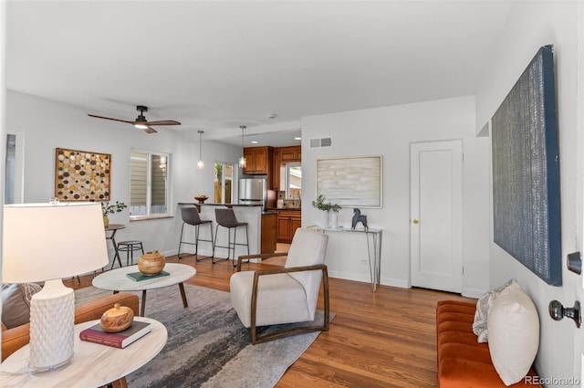 1177 Wabash St, Denver, CO 80220 - living area featuring a ceiling fan, light wood-type flooring, and baseboards