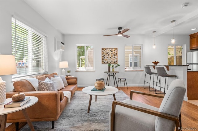 1177 Wabash St, Denver, CO 80220 - living room featuring a ceiling fan, light wood-type flooring, and baseboards