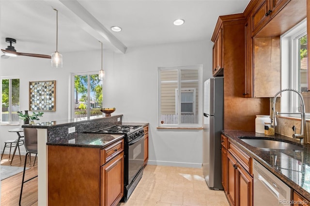 1177 Wabash St, Denver, CO 80220 - kitchen featuring dishwasher, black range with gas cooktop, freestanding refrigerator, a kitchen bar, and a sink
