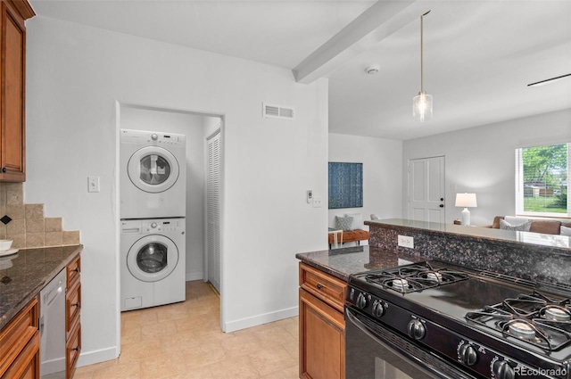 1177 Wabash St, Denver, CO 80220 - kitchen featuring black gas range oven, stacked washer / dryer, open floor plan, white dishwasher, and brown cabinets