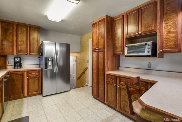 kitchen with built in desk and appliances with stainless steel finishes