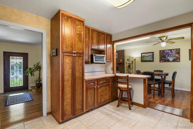 kitchen featuring light tile patterned floors and ceiling fan