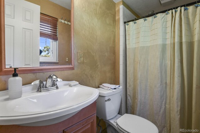 bathroom with vanity, walk in shower, and toilet