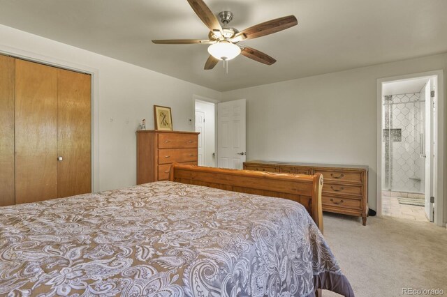 carpeted bedroom with a closet, ceiling fan, and ensuite bathroom