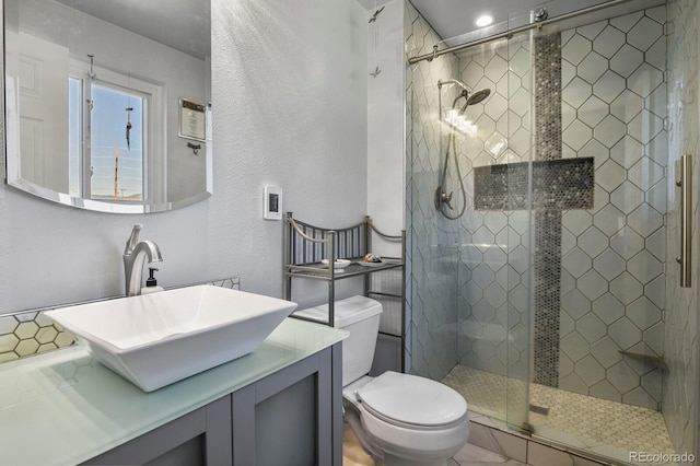 bathroom with vanity, an enclosed shower, and toilet