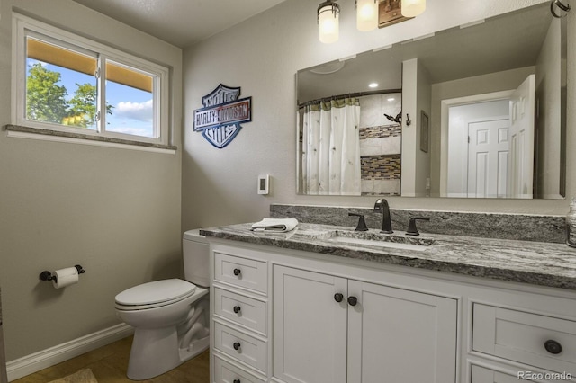 bathroom featuring a shower with curtain, vanity, and toilet