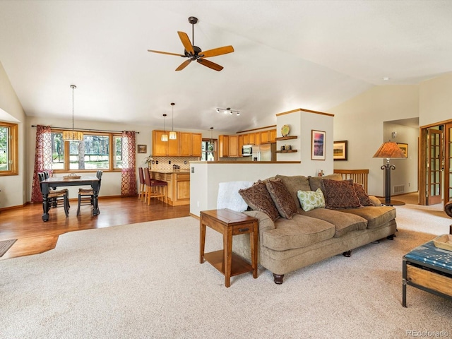 19795 Flint Ln, Morrison, CO 80465 - carpeted living room with lofted ceiling, ceiling fan, and wood finished floors