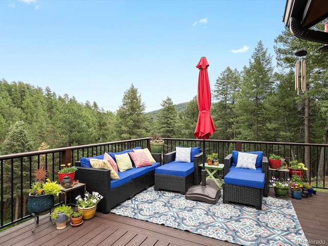 19795 Flint Ln, Morrison, CO 80465 - wooden deck featuring an outdoor living space and a wooded view