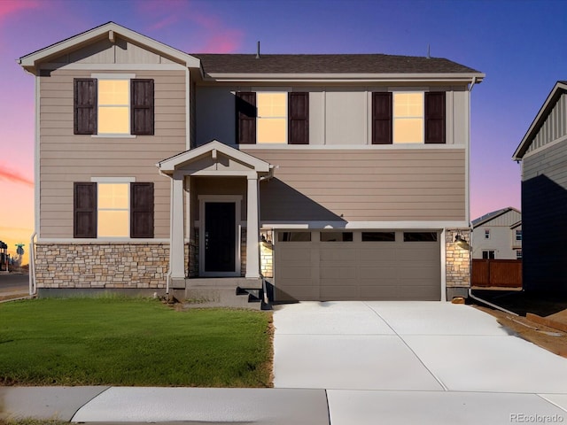 view of front of property with a garage and a lawn