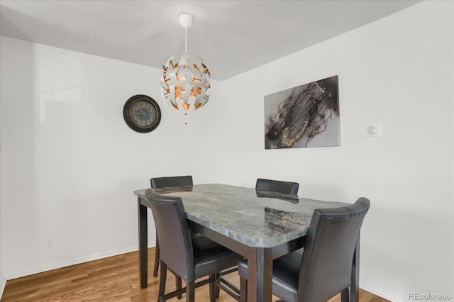 dining room featuring an inviting chandelier and hardwood / wood-style floors