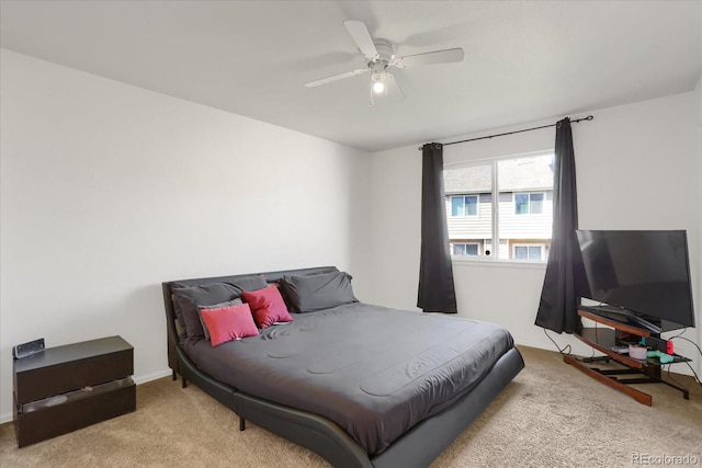 bedroom featuring ceiling fan and light carpet