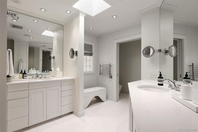 450 Steele St, Denver, CO 80206 - full bath featuring a skylight, crown molding, vanity, recessed lighting, and tile patterned flooring