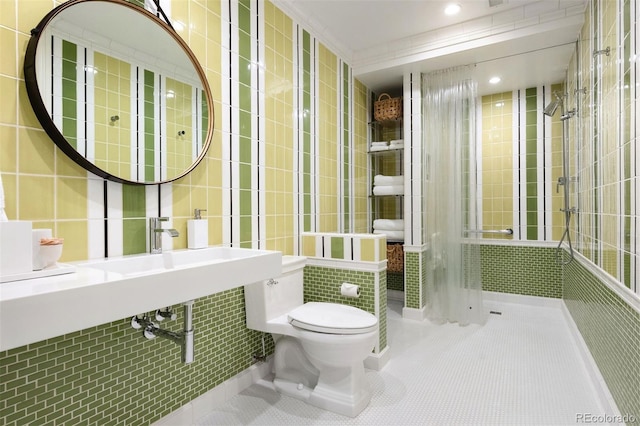 450 Steele St, Denver, CO 80206 - bathroom with tile patterned flooring, tile walls, a tile shower, and recessed lighting