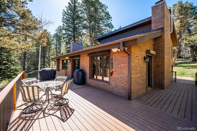 25357 Snyder Ave, Conifer, CO 80433 - wooden terrace with a grill and outdoor dining space