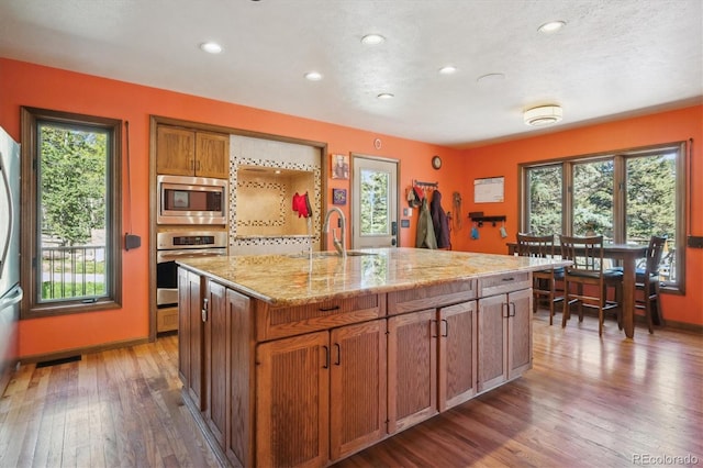 25357 Snyder Ave, Conifer, CO 80433 - kitchen with stainless steel appliances, wood finished floors, plenty of natural light, and recessed lighting