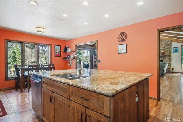 25357 Snyder Ave, Conifer, CO 80433 - kitchen with a sink, a kitchen island with sink, light wood-style flooring, light stone counters, and recessed lighting