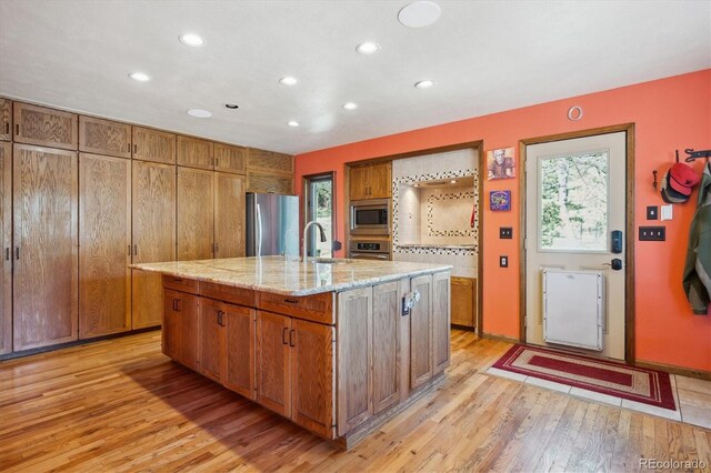 25357 Snyder Ave, Conifer, CO 80433 - kitchen with stainless steel appliances, light wood-style floors, recessed lighting, brown cabinets, and a sink