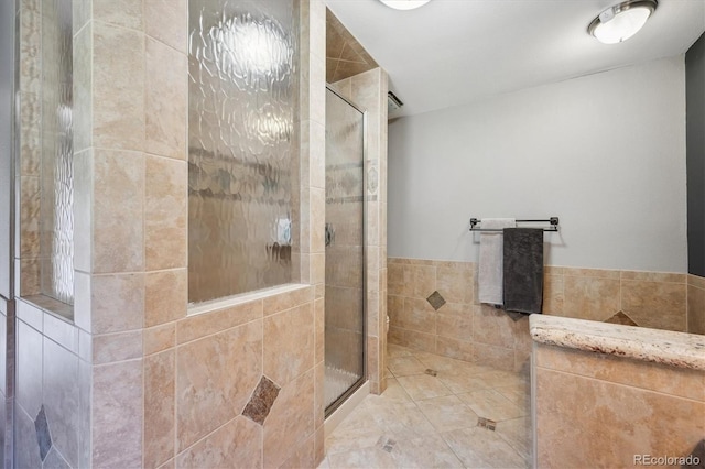 25357 Snyder Ave, Conifer, CO 80433 - full bathroom with tile walls, a shower stall, and a wainscoted wall