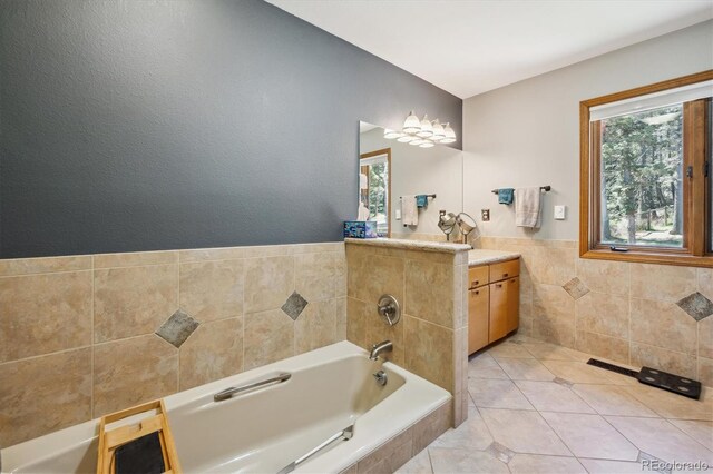 25357 Snyder Ave, Conifer, CO 80433 - full bath featuring tile walls, tile patterned floors, vanity, a garden tub, and wainscoting