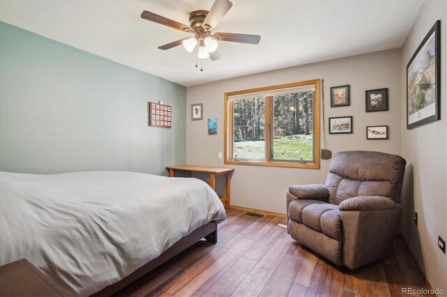 25357 Snyder Ave, Conifer, CO 80433 - bedroom with wood-type flooring, baseboards, and a ceiling fan