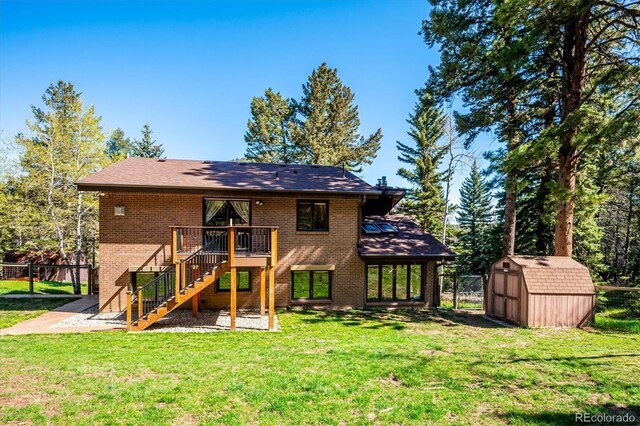 25357 Snyder Ave, Conifer, CO 80433 - rear view of house with stairway, a storage shed, brick siding, a deck, and an outdoor structure