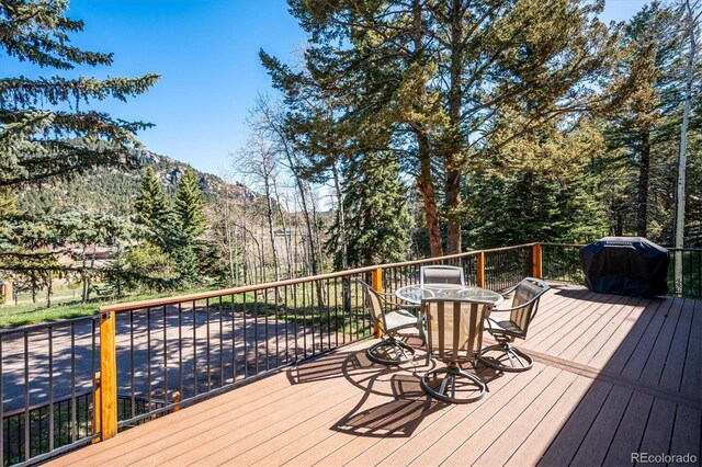 25357 Snyder Ave, Conifer, CO 80433 - wooden terrace with a mountain view, outdoor dining space, and area for grilling