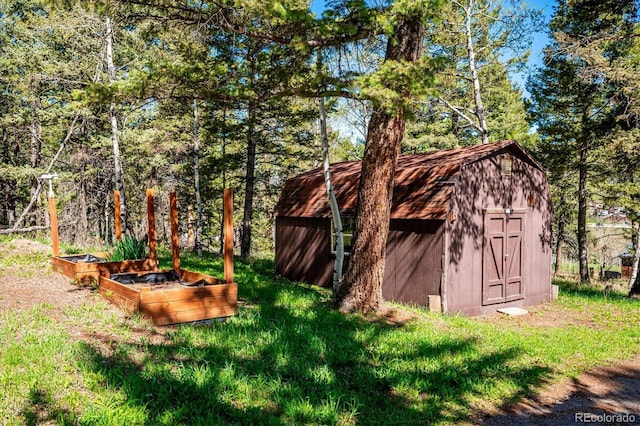 25357 Snyder Ave, Conifer, CO 80433 - view of yard with a storage shed, a vegetable garden, and an outbuilding