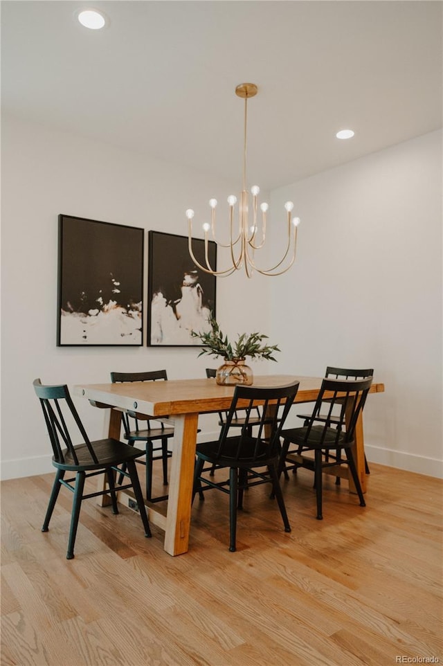 dining room featuring recessed lighting, a notable chandelier, light wood-style floors, and baseboards