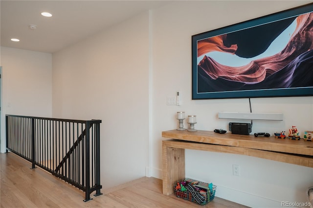 hallway featuring an upstairs landing, recessed lighting, baseboards, and wood finished floors