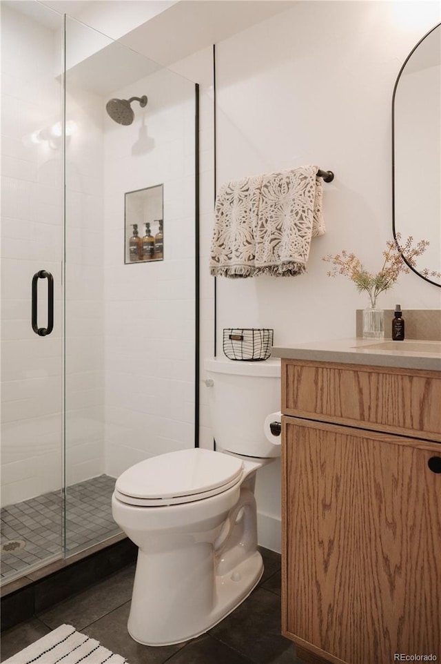 full bathroom with tile patterned flooring, a shower stall, toilet, and vanity