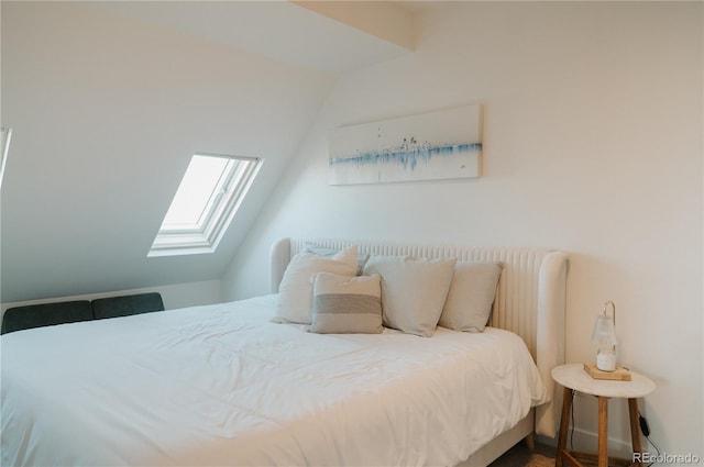 bedroom featuring lofted ceiling with skylight