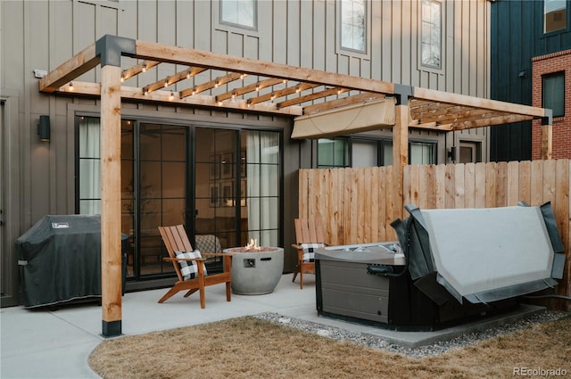 view of patio / terrace featuring fence, a pergola, and an outdoor fire pit