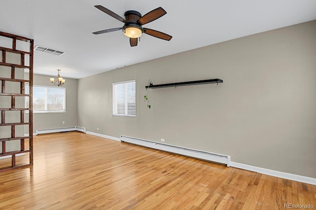 unfurnished room with a wealth of natural light, visible vents, light wood-style floors, and a baseboard radiator