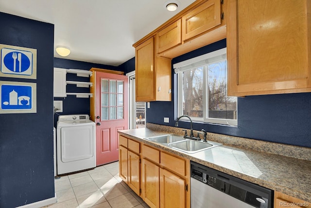 kitchen with stainless steel dishwasher, washer / clothes dryer, plenty of natural light, and a sink