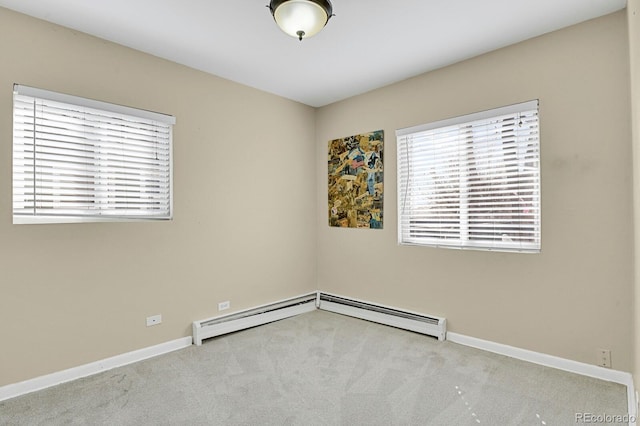 carpeted spare room featuring baseboards and baseboard heating