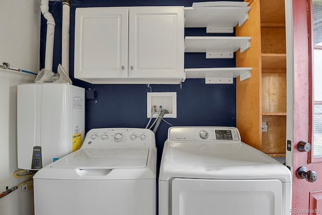 laundry area with cabinet space, tankless water heater, and washer and clothes dryer