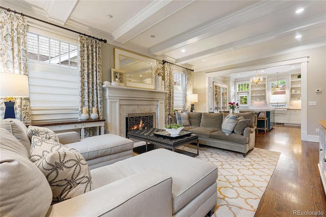 4535 E Montview Blvd, Denver, CO 80207 - living area with wood finished floors, beam ceiling, a fireplace, a chandelier, and crown molding