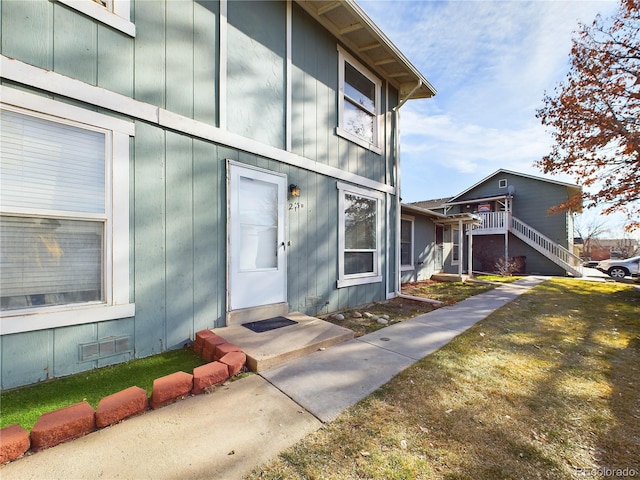 view of exterior entry with a lawn