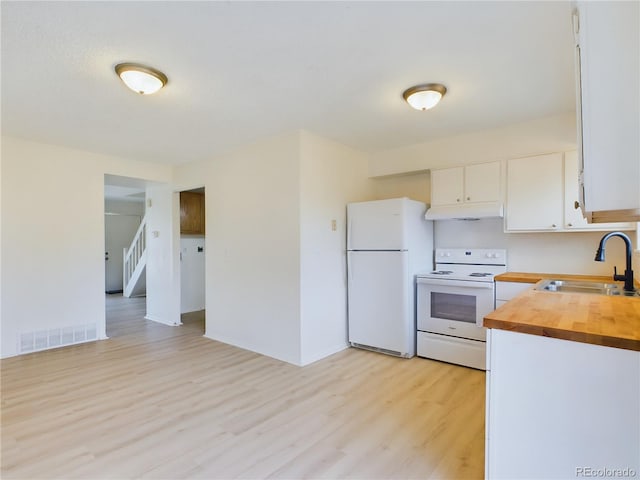 kitchen with wooden counters, sink, white appliances, white cabinetry, and light wood-type flooring