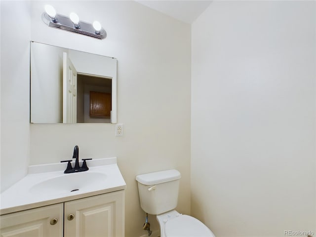 bathroom with toilet and vanity