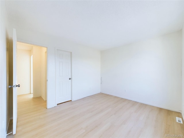 spare room with light hardwood / wood-style floors