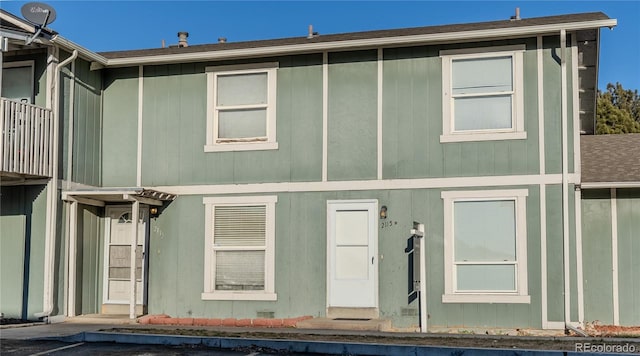 back of house featuring a balcony