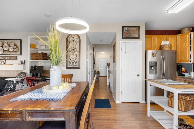 19707 E 59th Pl, Aurora, CO 80019 - kitchen with light wood-style flooring and stainless steel fridge with ice dispenser