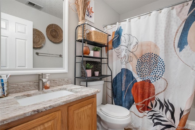 19707 E 59th Pl, Aurora, CO 80019 - full bathroom with a shower with shower curtain, vanity, visible vents, and toilet