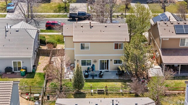 19707 E 59th Pl, Aurora, CO 80019 - back of house featuring a fenced backyard, a patio, and a lawn