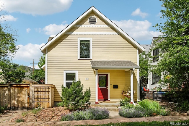view of front of home featuring fence and a gate
